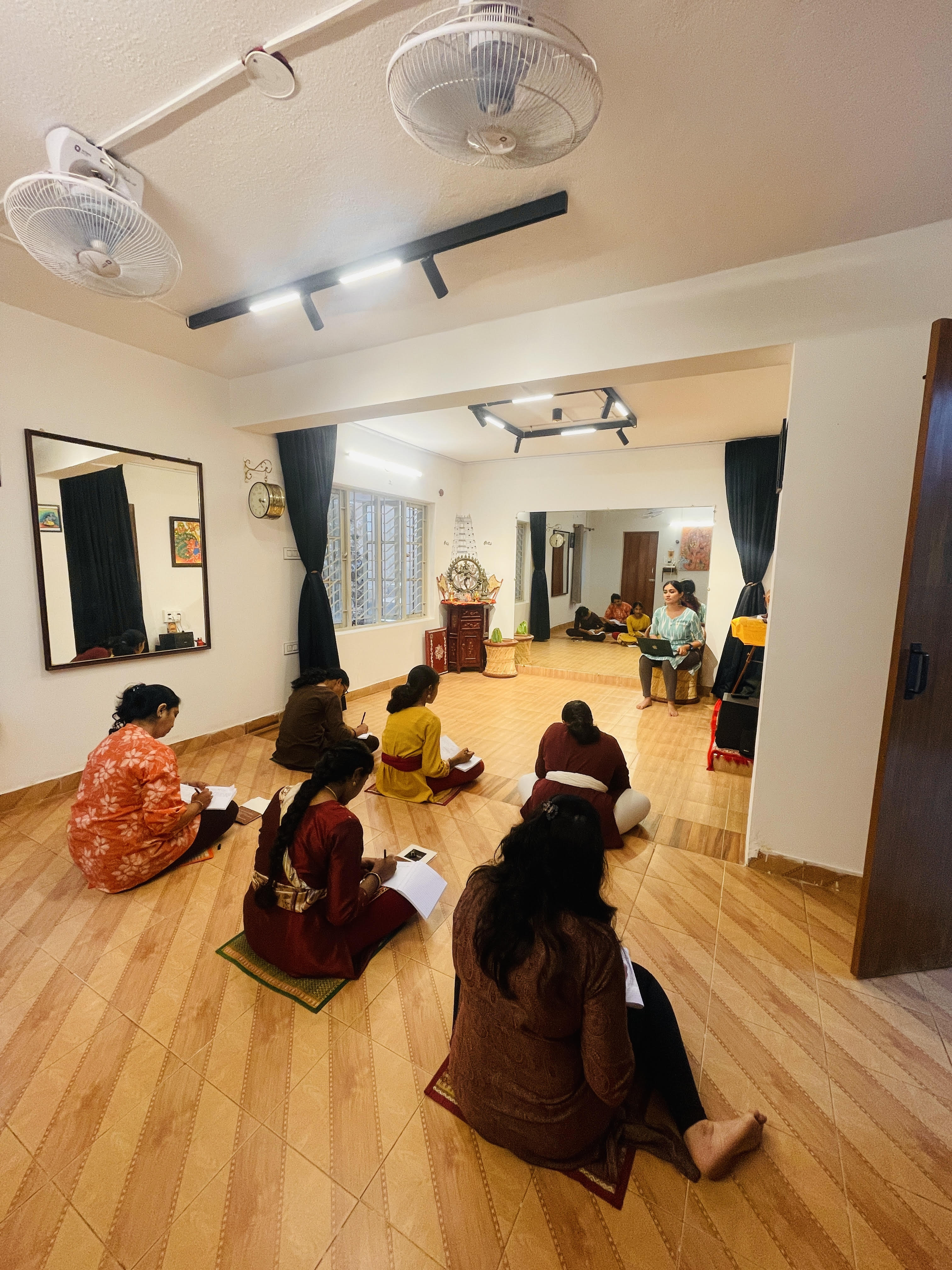 Students practicing Bharatanatyam techniques during intensive dance training session